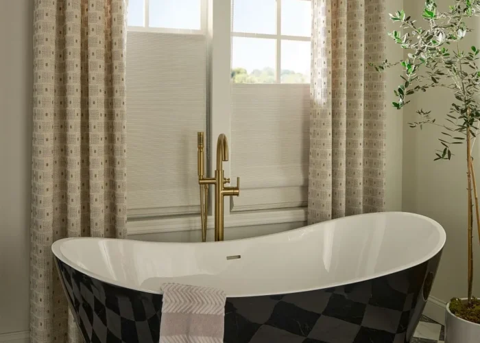 woven wood shades Austin TX bathroom installation with layered drapery and freestanding tub