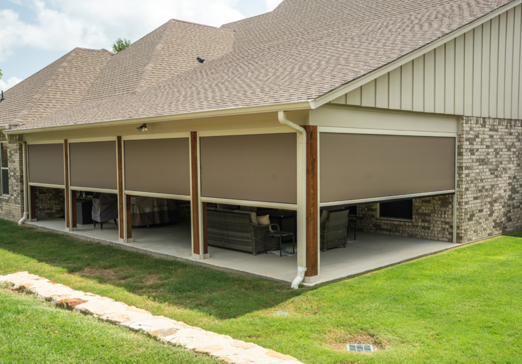 Motorized exterior patio shades installed on a covered backyard patio in Austin, TX, providing sun protection, privacy, and shade for outdoor seating and entertaining.