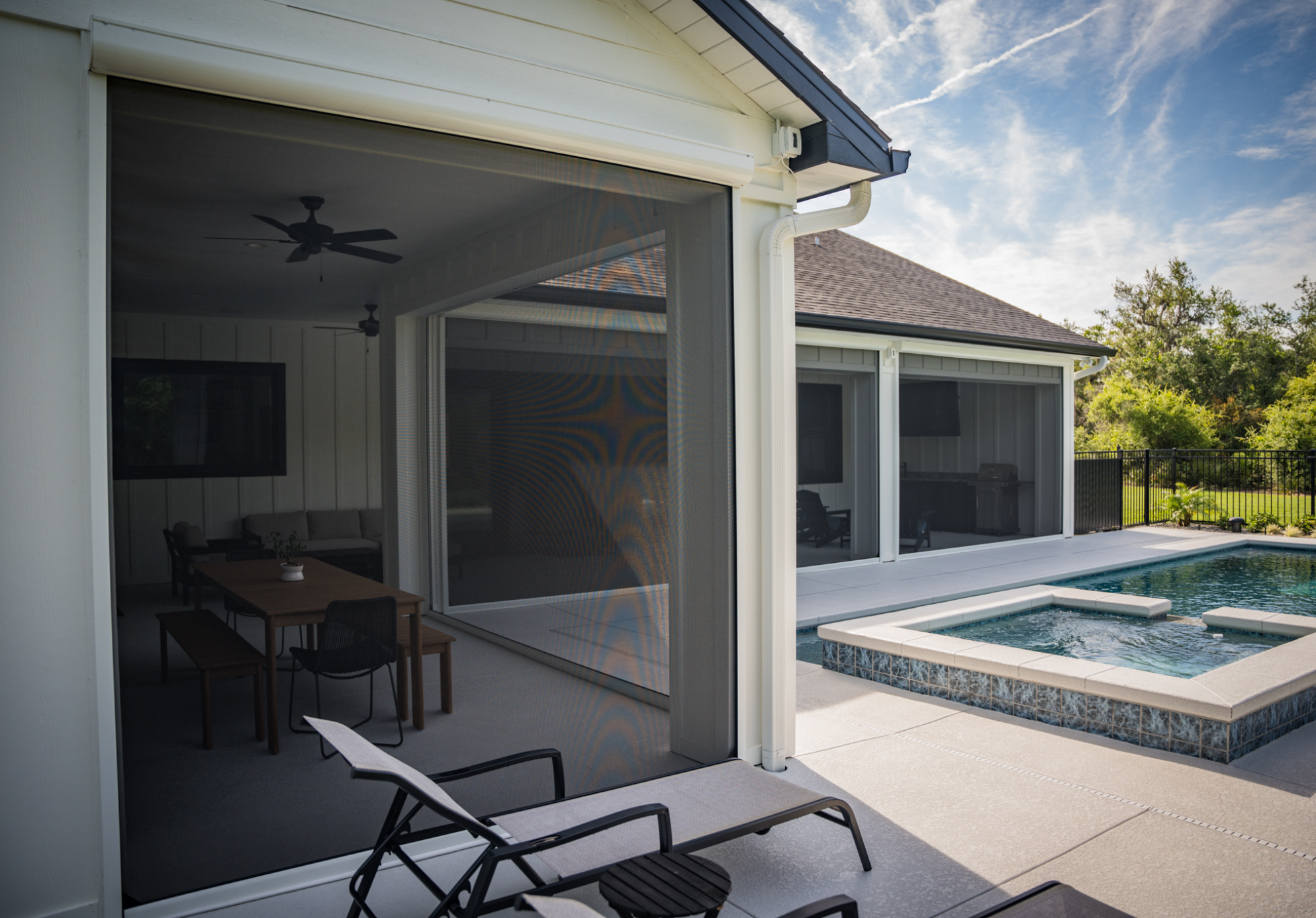 How to keep your patio cooler in Austin with motorized exterior shades on a covered poolside patio, providing shade, privacy, glare reduction, and heat control for outdoor living spaces.