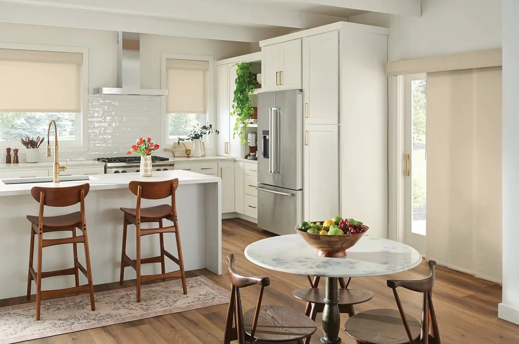 Motorized shades for sliding glass doors Austin TX installed in a modern kitchen, featuring clean roller shades that provide smooth operation, privacy, and light control across large glass openings.