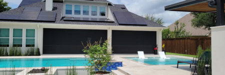 Motorized exterior shades installed on a covered patio overlooking a backyard pool in Austin.