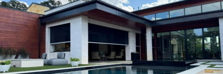 Motorized exterior shades installed on a luxury covered patio beside a modern pool in Austin.
