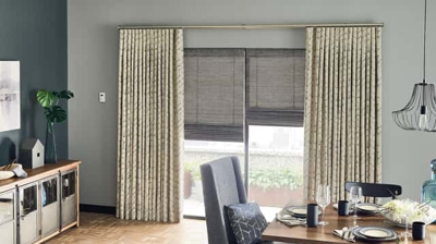 dining room with a sliding glass door or large window - with roman shades and drapery layered