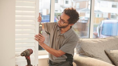 professional installer installing shutters
