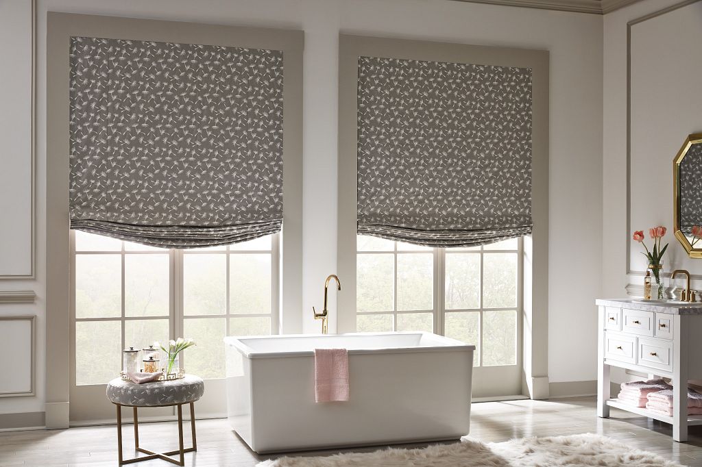 Luxurious Bathroom Featuring Patterned Roman Shades and Classic Decor
