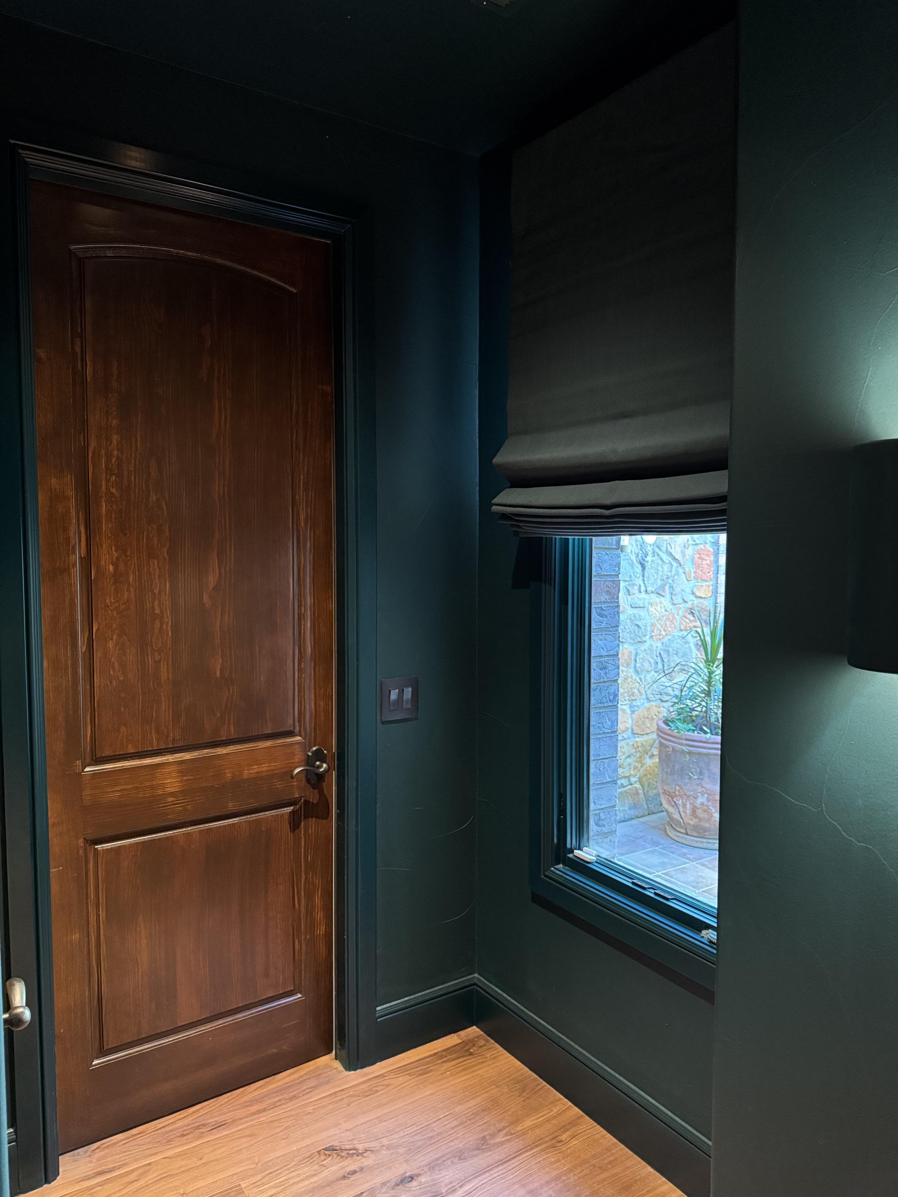 Moody, modern, and a little mysterious — this dark teal Roman shade completes the look.