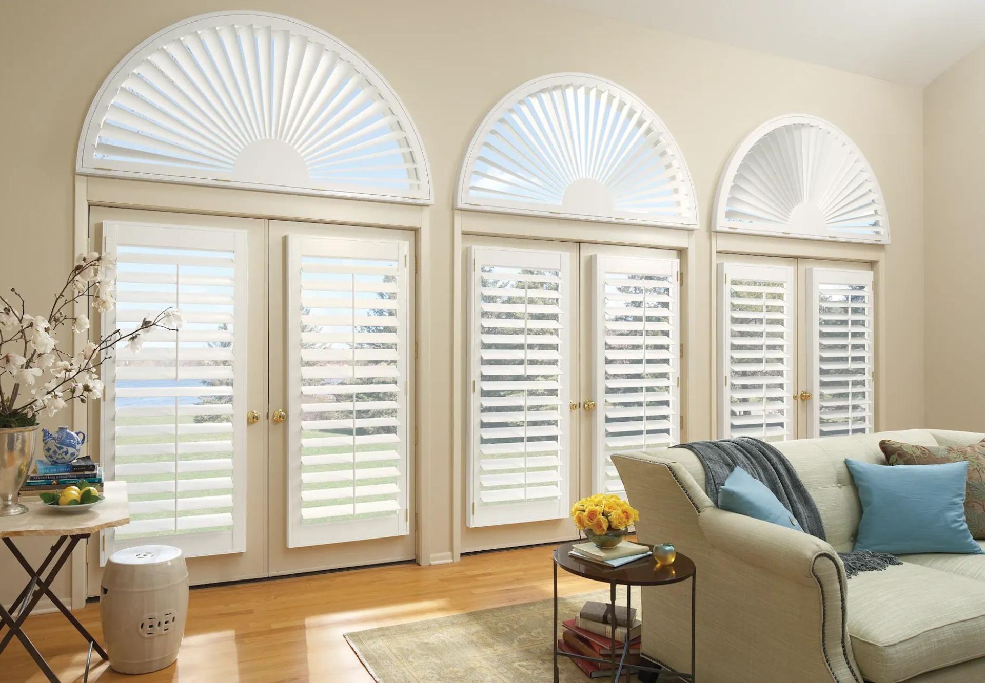 Elegant Living Room with Custom Plantation Shutters and Arched Windows