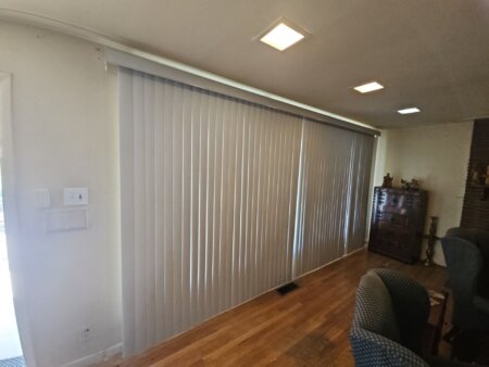 Professional vertical blind installation in a Littleton-area living room.