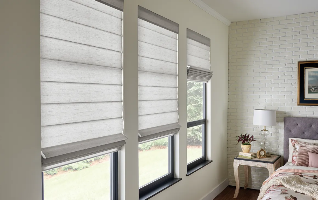 Roman shades on windows in a bedroom
