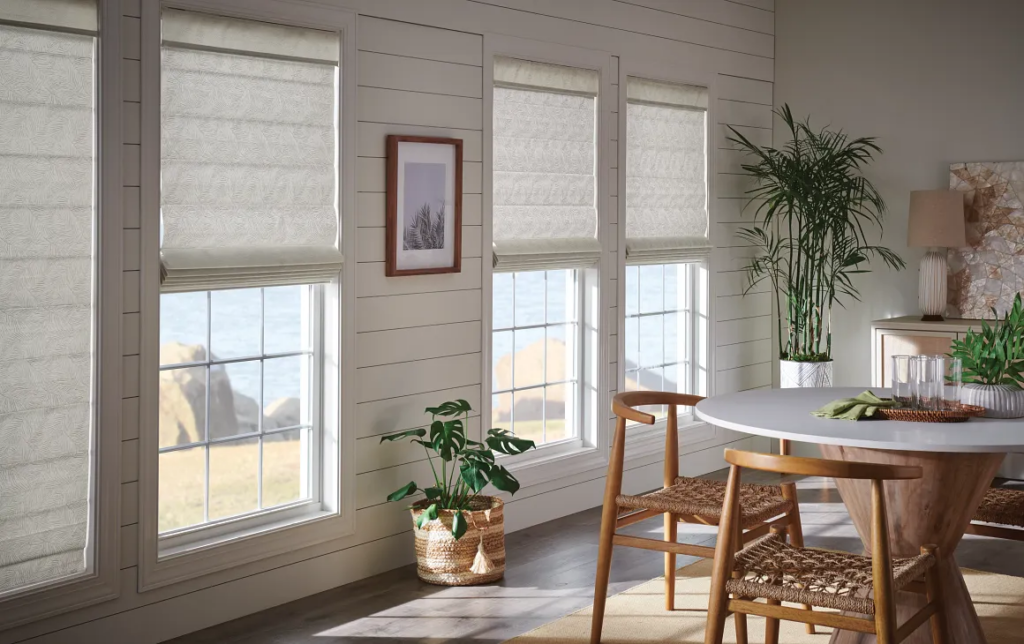 White Roman shades on windows in a dining room