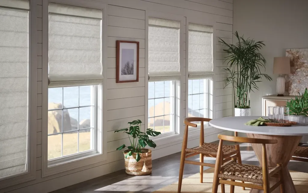 White Roman shades on windows in a dining room