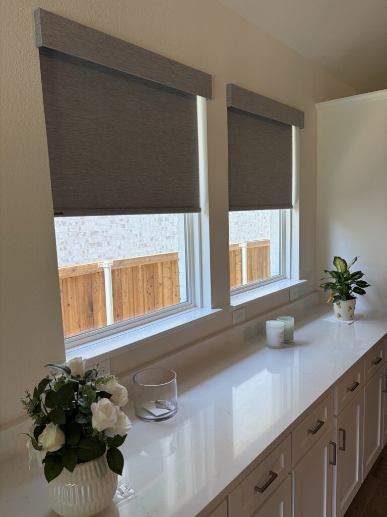 Room darkening roller shades in a new construction home in Fate Texas