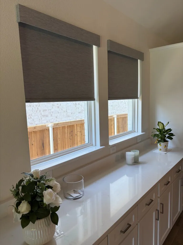 Room darkening roller shades in a new construction home in Fate Texas